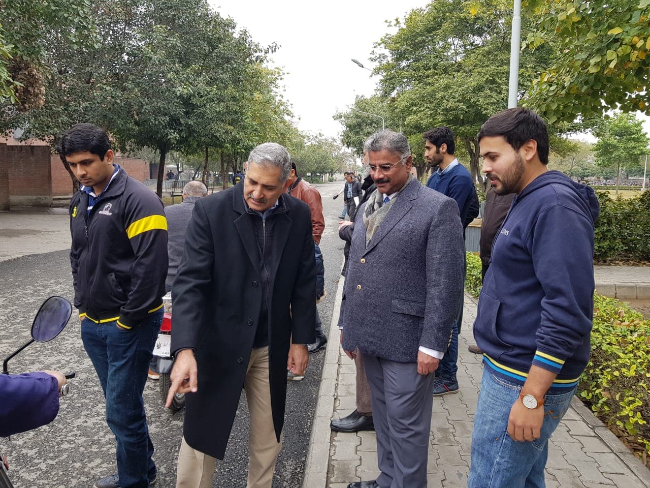 LUMS professors taking a closer look at a Jolta electric motorcycle